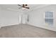 Spacious main bedroom features neutral carpet, ceiling fan and two windows at 1302 Paint Horse Ct, Mount Pleasant, SC 29429