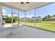 View from a screened porch overlooking a scenic pond and well-maintained backyard with neighbor houses at 1302 Paint Horse Ct, Mount Pleasant, SC 29429