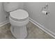 Close-up of elongated white toilet with tile flooring in half-bathroom at 1302 Paint Horse Ct, Mount Pleasant, SC 29429