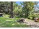 A spacious backyard features a picnic table and mature trees for outdoor living and shade at 131 Wedgewood Cir, Goose Creek, SC 29445