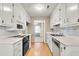 Galley kitchen featuring white cabinets, appliances, and laminate countertops at 131 Wedgewood Cir, Goose Creek, SC 29445