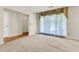 A cozy living room features plush carpeting and an elegantly draped window at 131 Wedgewood Cir, Goose Creek, SC 29445