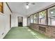 Bright sunroom featuring large windows, brick accents, and a ceiling fan at 131 Wedgewood Cir, Goose Creek, SC 29445