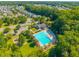 This aerial view showcases a sparkling community pool near meticulously maintained green spaces and beautiful, mature trees at 135 Gaslight Blvd, Summerville, SC 29483