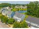 Aerial view of a residential neighborhood featuring mature trees, a pond, and well-maintained properties at 135 Gaslight Blvd, Summerville, SC 29483