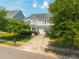 Charming two-story home with a well-maintained lawn, mature trees, and attached two-car garage at 135 Gaslight Blvd, Summerville, SC 29483