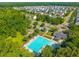 An aerial image shows an amazing pool surrounded by mature trees and well-manicured lawns at 135 Gaslight Blvd, Summerville, SC 29483