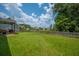 Expansive backyard enclosed by a wooden fence and featuring a covered patio at 135 Gaslight Blvd, Summerville, SC 29483