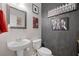 Charming half-bathroom featuring vanity sink, toilet, modern mirror, and themed décor at 135 Gaslight Blvd, Summerville, SC 29483