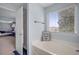 This bright bathroom features a soaking tub, shower, and view to the main bedroom at 135 Gaslight Blvd, Summerville, SC 29483