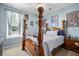 Comfortable bedroom with a wood poster bed frame, soft blue walls, and natural light from the window at 135 Gaslight Blvd, Summerville, SC 29483