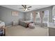 This bedroom features a ceiling fan, carpeted floors and large window at 135 Gaslight Blvd, Summerville, SC 29483