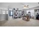 Spacious bonus room with unique décor, ceiling fan, neutral carpeting, and decorative display shelving at 135 Gaslight Blvd, Summerville, SC 29483