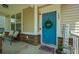 Welcoming front entrance with a stylish blue door, decorative wreath, and cozy seating area at 135 Gaslight Blvd, Summerville, SC 29483