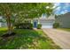 Beautiful two-story home with mature landscaping, a manicured lawn, and attached two-car garage at 135 Gaslight Blvd, Summerville, SC 29483