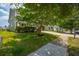 Lovely home featuring a green lawn, sidewalk and mature landscaping at 135 Gaslight Blvd, Summerville, SC 29483