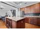 Modern kitchen island featuring granite countertops, barstool seating, and stainless steel appliances at 135 Gaslight Blvd, Summerville, SC 29483