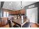 Well-lit kitchen dining area with a dark wood table, seating for four, and pantry access at 135 Gaslight Blvd, Summerville, SC 29483