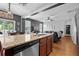 Open-concept kitchen featuring a center island with sink, stainless steel appliances, and warm wood cabinetry at 135 Gaslight Blvd, Summerville, SC 29483