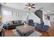Cozy and stylish living room features a large sofa, armchairs, a wooden coffee table, and hardwood floors at 135 Gaslight Blvd, Summerville, SC 29483
