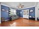Comfortable living room with dark-blue walls, stylish furniture, natural light from the window, and hardwood flooring at 135 Gaslight Blvd, Summerville, SC 29483