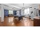 Bright and open living room features hardwood flooring, neutral walls, and a stylish pool table for entertainment at 135 Gaslight Blvd, Summerville, SC 29483