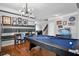 Relax in this living space with a pool table, stainless steel refrigerator, wood floors, and decorative wall art at 135 Gaslight Blvd, Summerville, SC 29483