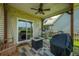 Relaxing covered patio features a ceiling fan, string lights, swing, and stylish outdoor furniture at 135 Gaslight Blvd, Summerville, SC 29483