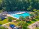 A sparkling pool surrounded by lush greenery offers a serene escape, with ample lounge chairs and playground at 135 Gaslight Blvd, Summerville, SC 29483