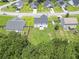 An aerial view displays a neighborhood with well-maintained lawns and varied home styles at 1350 Pinyon Pine Dr, Ladson, SC 29456