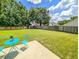 Expansive backyard with lush lawn, mature trees, and patio seating area at 1350 Pinyon Pine Dr, Ladson, SC 29456