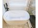 Modern bathroom featuring a freestanding soaking tub and a sleek black faucet set against a bright window at 1350 Pinyon Pine Dr, Ladson, SC 29456