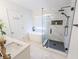 Bathroom featuring a soaking tub and a glass-enclosed shower with marble surround and matte black fixtures at 1350 Pinyon Pine Dr, Ladson, SC 29456