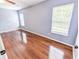 Spacious bedroom with gleaming hardwood floors and natural light streaming through large windows at 1350 Pinyon Pine Dr, Ladson, SC 29456