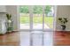 Dining area with hardwood floors, leading to sliding glass doors showcasing the backyard at 1350 Pinyon Pine Dr, Ladson, SC 29456