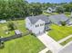 Aerial exterior showing a two-story home with a well-manicured lawn, driveway, and partial fencing at 1350 Pinyon Pine Dr, Ladson, SC 29456