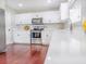 Bright, modern kitchen featuring white cabinets, stainless steel appliances, and hardwood floors at 1350 Pinyon Pine Dr, Ladson, SC 29456