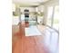 Open kitchen layout with stainless steel appliances, hardwood floors, and sliding doors to the backyard at 1350 Pinyon Pine Dr, Ladson, SC 29456