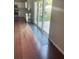 View from the living room showcasing hardwood floors and a sliding glass door to the backyard at 1350 Pinyon Pine Dr, Ladson, SC 29456