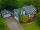 Aerial view of a two story home with well manicured lawn and a detached garage at 138 Shadowmoss Pkwy, Charleston, SC 29414