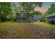 Expansive backyard featuring a screened porch and mature trees offering a private outdoor space at 138 Shadowmoss Pkwy, Charleston, SC 29414