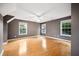 Large bedroom with hardwood floors, light brown walls, and three windows at 138 Shadowmoss Pkwy, Charleston, SC 29414