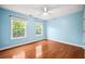 This bedroom features hardwood floors, light blue walls, and two windows at 138 Shadowmoss Pkwy, Charleston, SC 29414