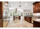 Gourmet kitchen with stainless appliances, tile backsplash, dark cabinets, and a large island for entertaining at 138 Shadowmoss Pkwy, Charleston, SC 29414