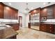 Spacious kitchen featuring dark cabinetry, stainless steel appliances, tile floors, and granite countertops at 138 Shadowmoss Pkwy, Charleston, SC 29414