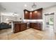 Well-lit kitchen with dark cabinets, stainless steel appliances, granite countertops, and tile flooring at 138 Shadowmoss Pkwy, Charleston, SC 29414