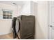 Bright laundry room features modern washer/dryer, cabinets, window, and a door at 138 Shadowmoss Pkwy, Charleston, SC 29414