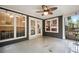 Screened porch with stained concrete flooring, ceiling fan, and multiple windows at 138 Shadowmoss Pkwy, Charleston, SC 29414