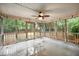 Screened porch with stained concrete flooring, ceiling fan, and backyard view at 138 Shadowmoss Pkwy, Charleston, SC 29414