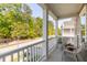 Charming covered porch with comfortable seating and a view of the lush surroundings at 1417 Roustabout Way, Charleston, SC 29414